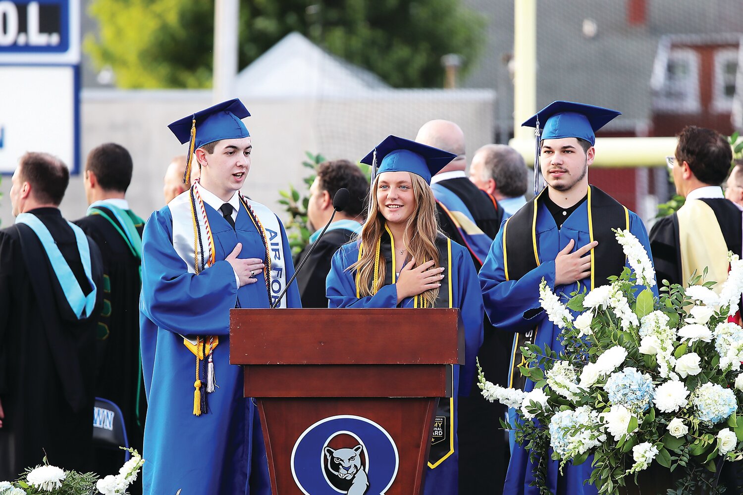 From left: W. Connor Frisch, Carlee Roesener, and Chris Owens say the Pledge of Allegiance. They had the highest GPAs among graduating seniors who are joining the military. Frisch is joining the U.S. Air Force, Roesener is joining the Pennsylvania Army National Guard, and Owens is joining the U.S. Army.