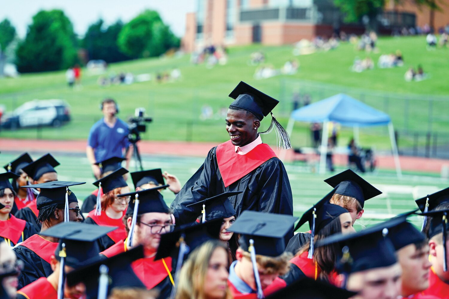 A member of the Class of 2024 makes his way through a sea of other graduates.