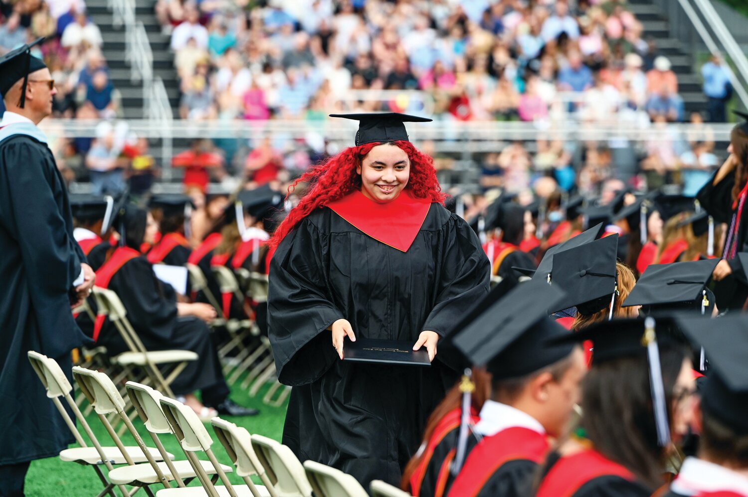 A William Tennent senior returns to her seat with her diploma in hand.