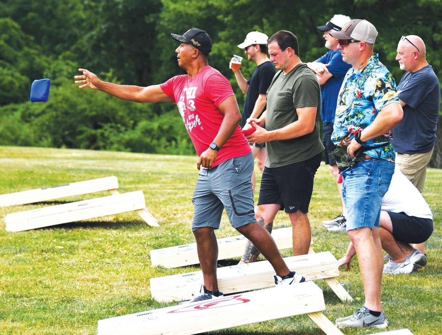 Win Young tosses a bean bag at the inaugural  Cornhole Tournament that raises money for the Families Behind the Badge Children’s Foundation.