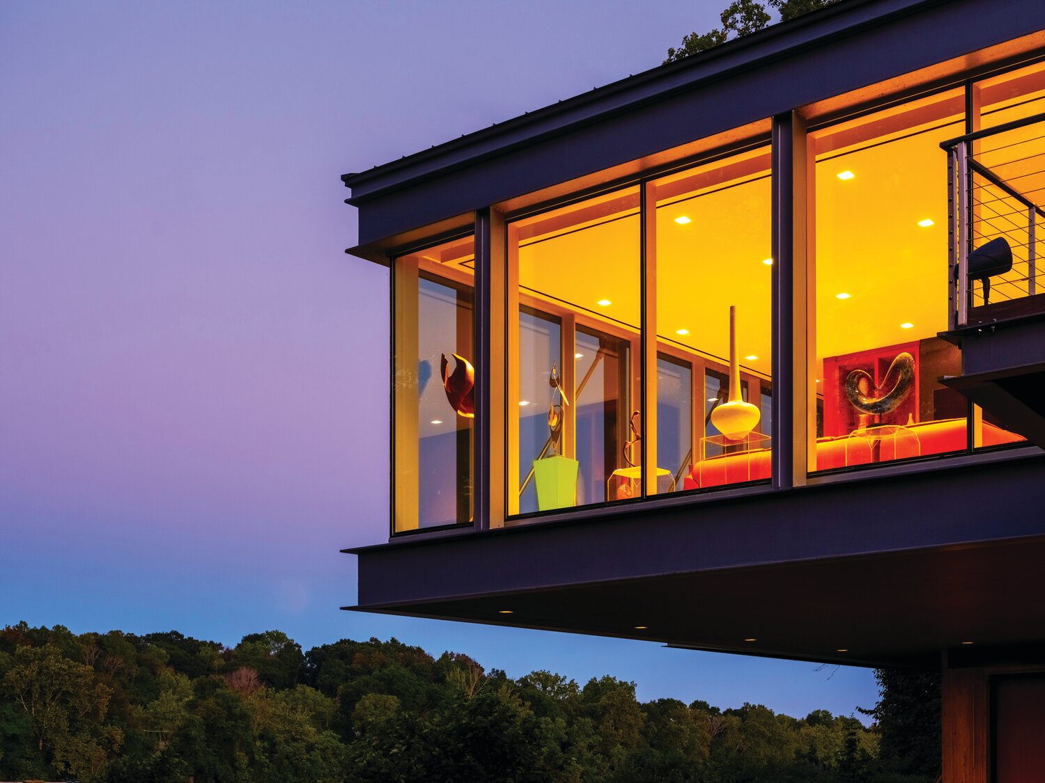 Set against a purple sky, the River Road Residence overlooks the Delaware River in Solebury.
