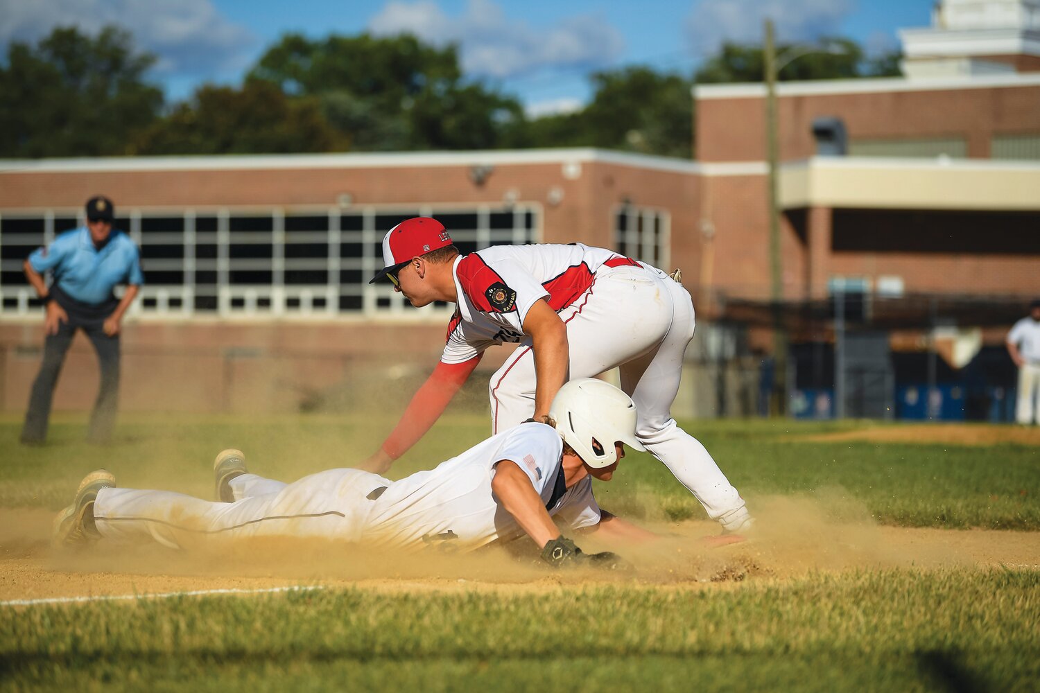 Doylestown's Ernie Sanchez slides into third base ahead of the throw to Souderton’s Joey Nase in the seven-run first inning.