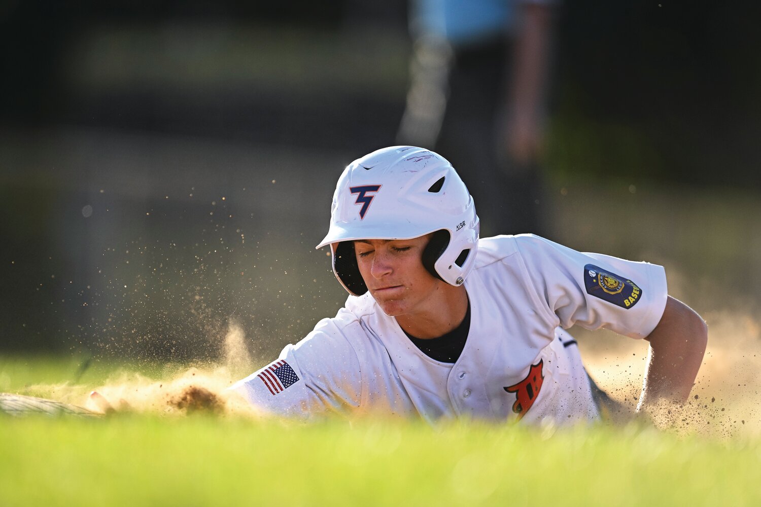 Doylestown’s Bobby Seaner slides back into first base during a third-inning pickoff attempt.