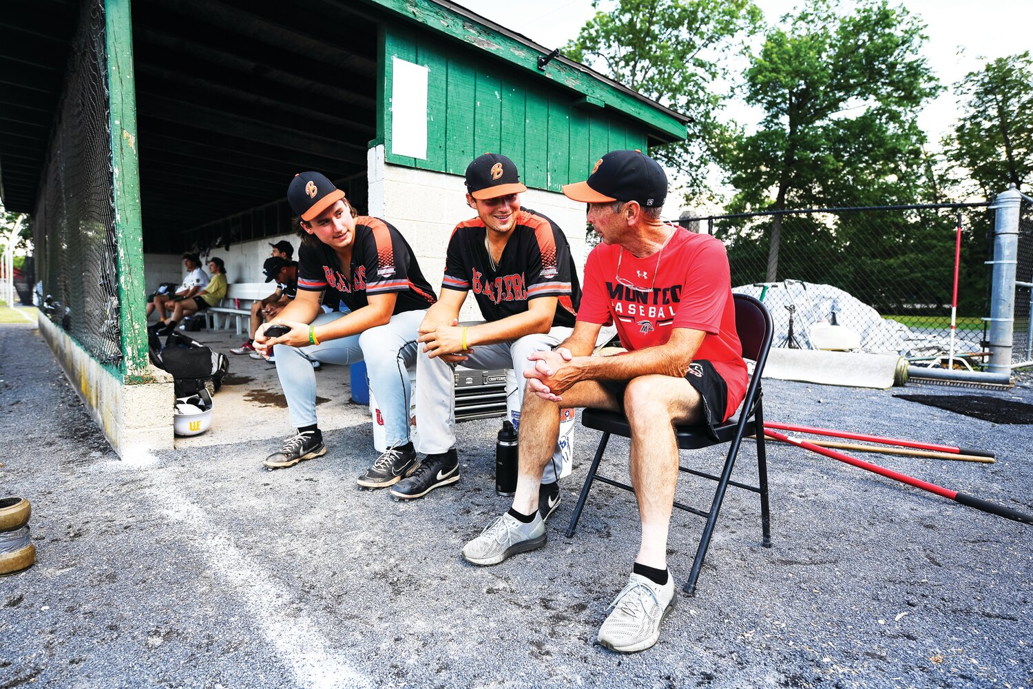 Quakertown Blazers players Kannon Zdimal and Mason Woolwine relax before the start of the Home Run Derby with coach Mike Fitzgerald.