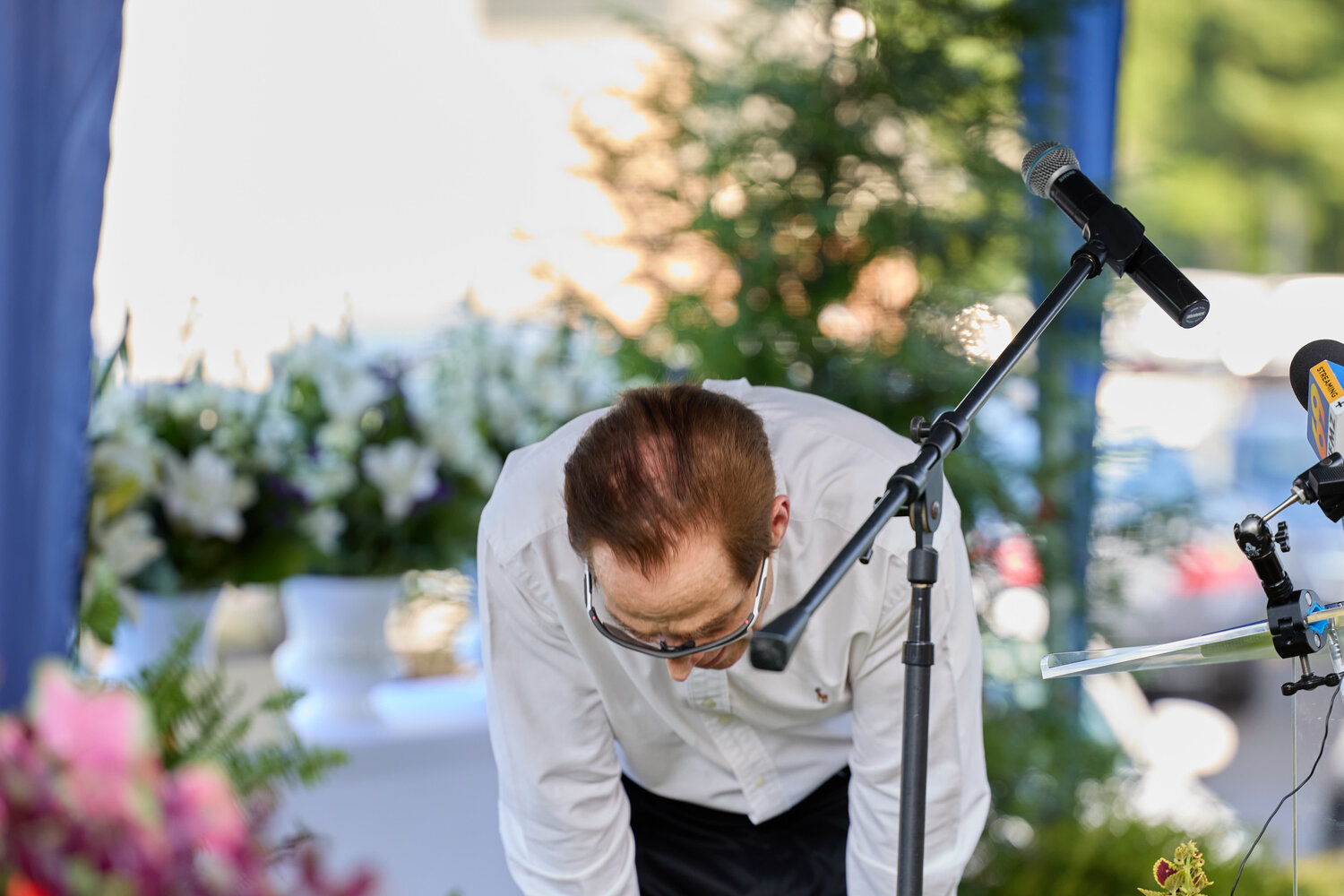 Dave Love, whose wife Yuko died in the flood, bows and voices regret for not having done more to protect her.