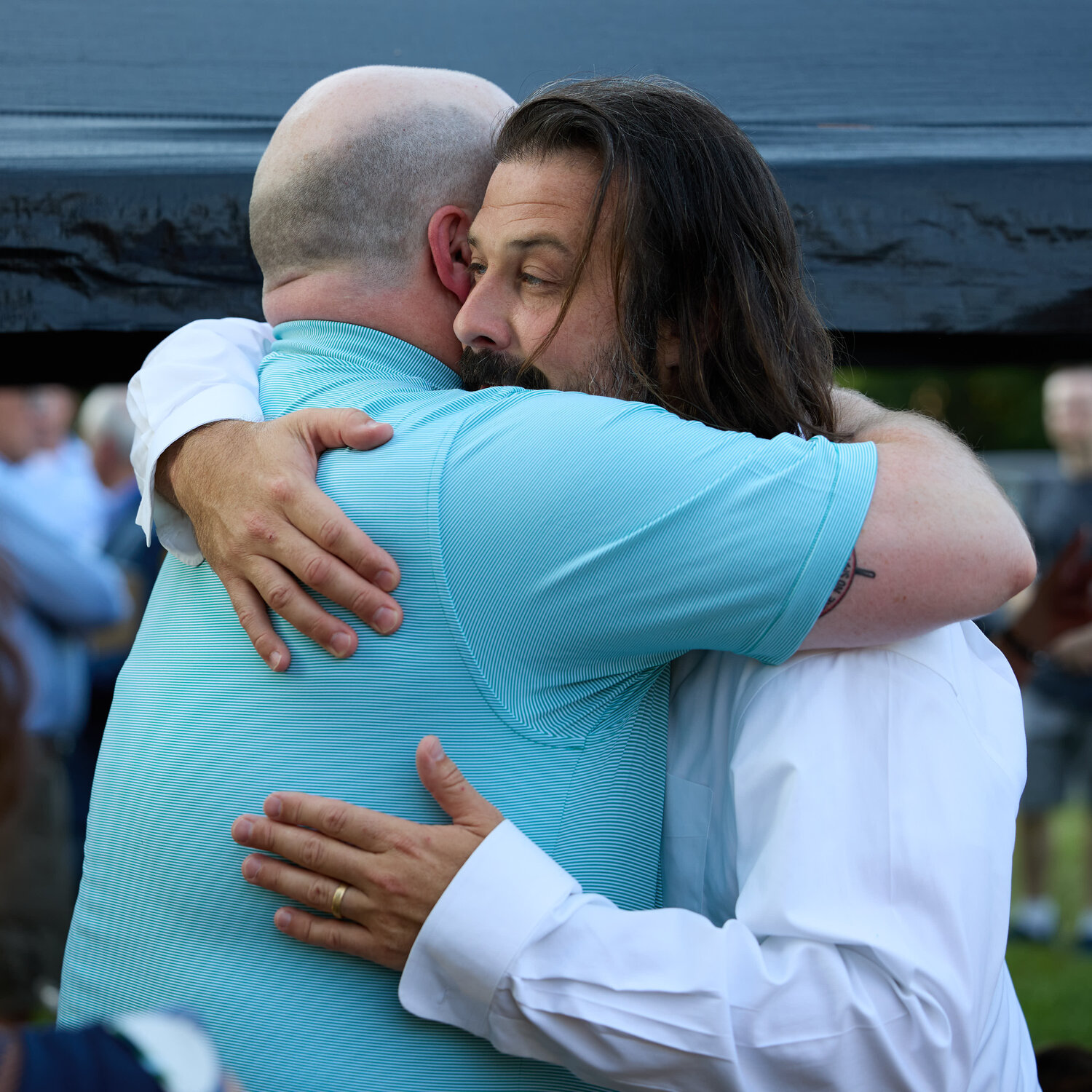 Zach DePiero accepts a hug at Monday’s service.