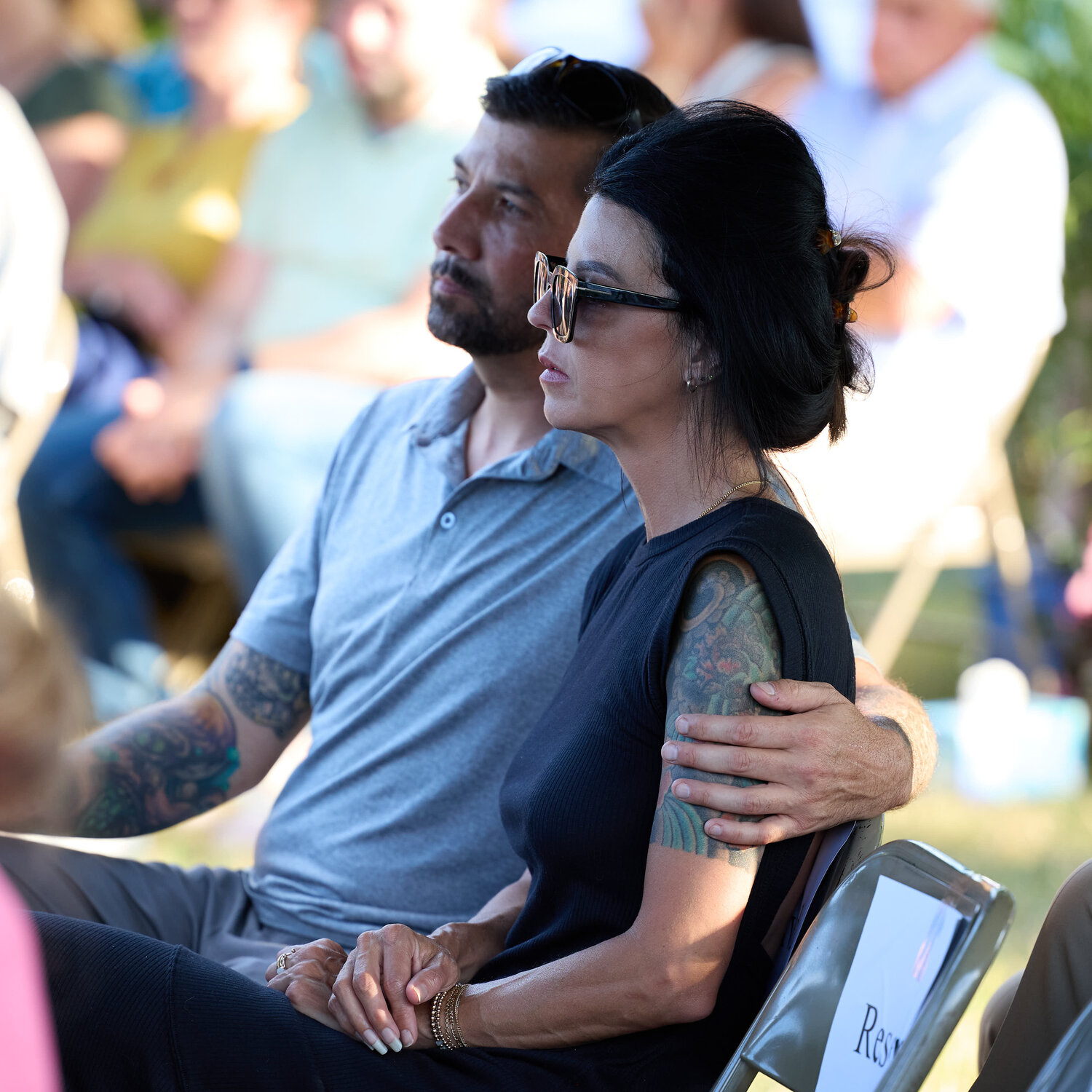 Justin Huizing, of Newtown, and his wife, flood survivor Jaime Sosonkin, listen to the speakers at The Crossing’s service to make the anniversary of last July’s fatal flash flood.