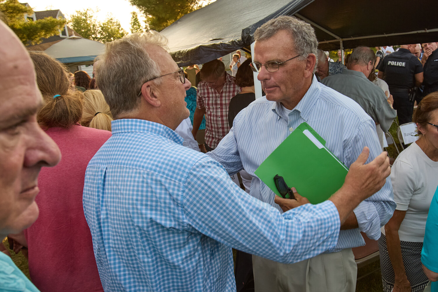 Paul Sheils, right, who lost two grandchildren in the flash flood, is comforted.