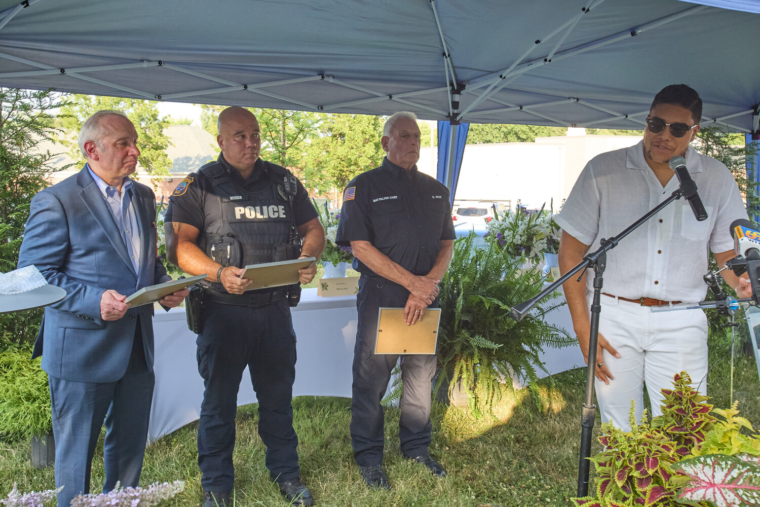 The Crossing lead pastor George Matthew Clash speaks during the memorial service for the seven victims of the flash flood that killed seven people last July. Behind him are, from left, Upper Makefield Township Supervisor Tom Cino, Officer Harry Vitello and Battalion Chief Dave Wise.