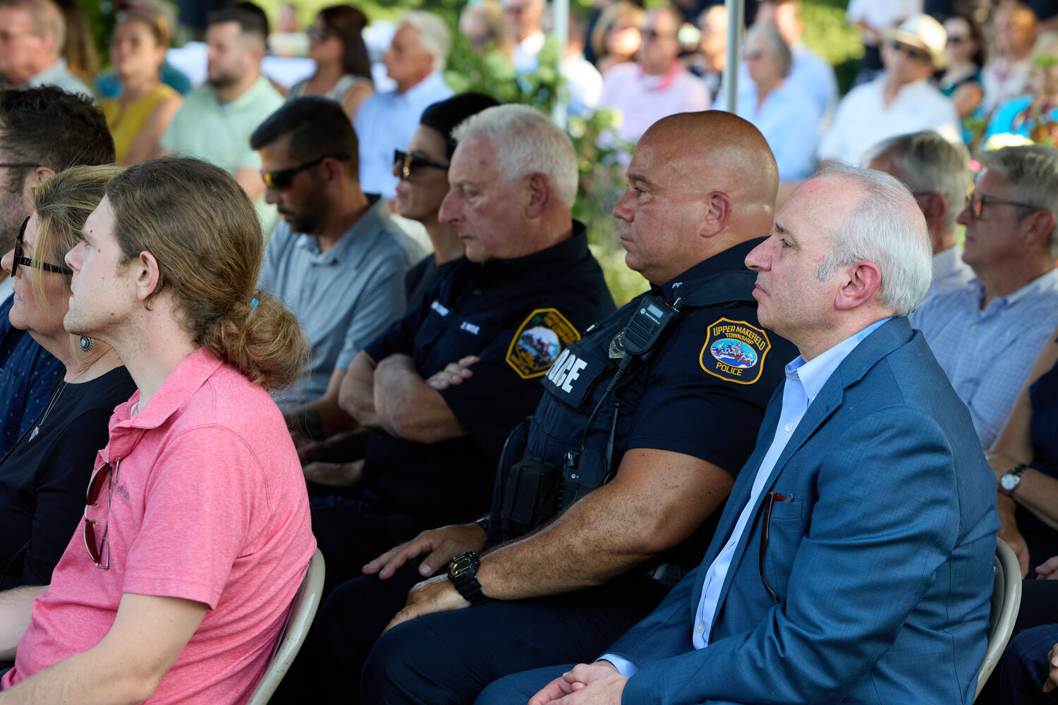 Upper Makefield Township Supervisor Tom Cino, right, Officer Harry Vitello, center right, and Battalion Chief Dave Wise, center left, listen to the speakers.