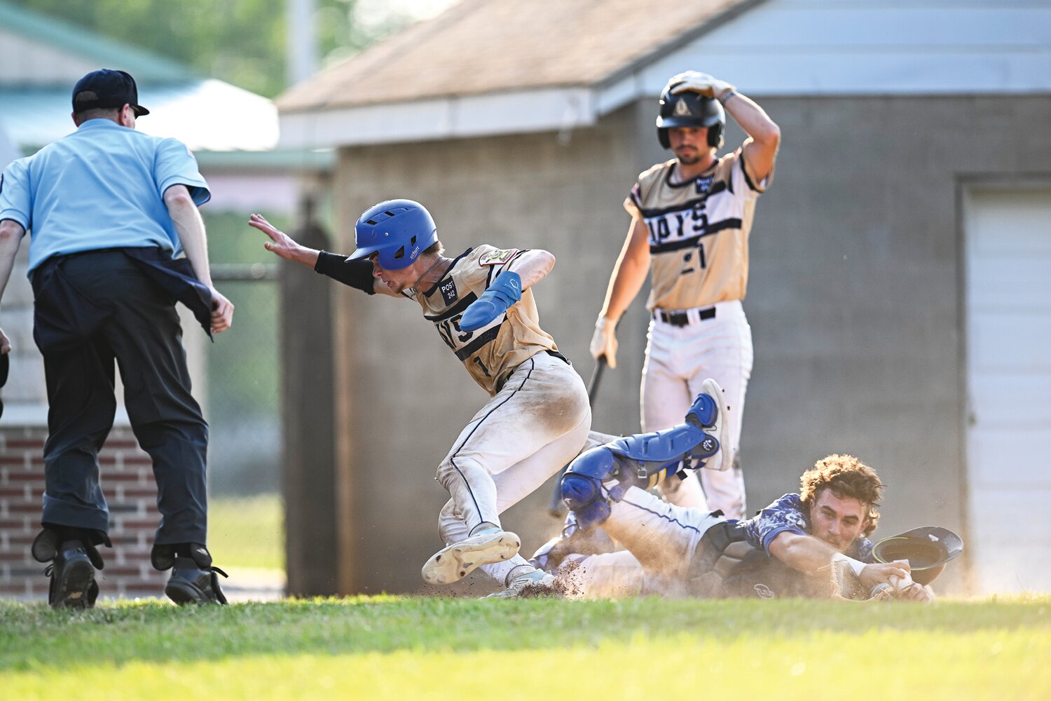 Quakertown’s Caleb Everitt avoids the diving tag attempt of Perkiomen catcher Brayden Adam and scores on a wild pitch in a four-run fifth inning, making the score 7-2.