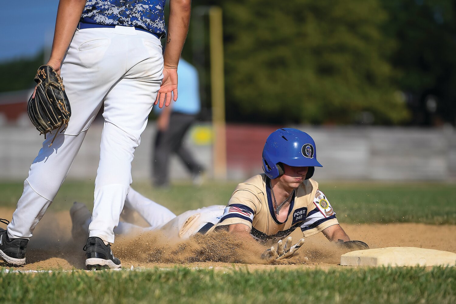 Carver Perrone goes from first to third and slides in safely ahead of the throw during the third inning.