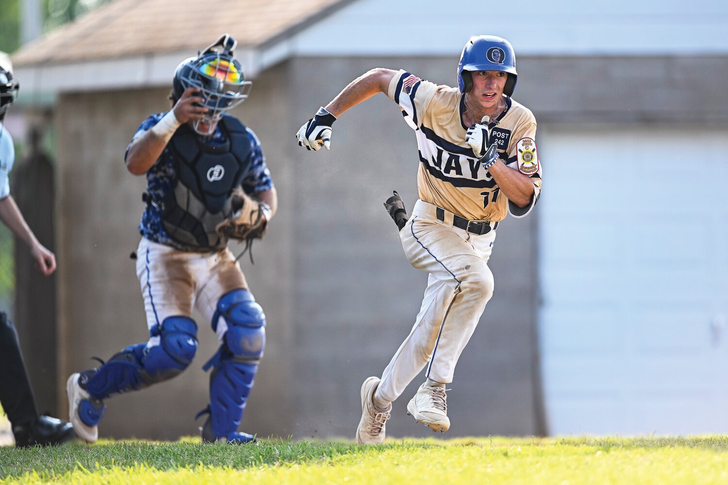 Quakertown’s Carver Perrone hustles out a dropped third strike and reaches first base safely after a throwing error by Perkiomen in the fifth inning.