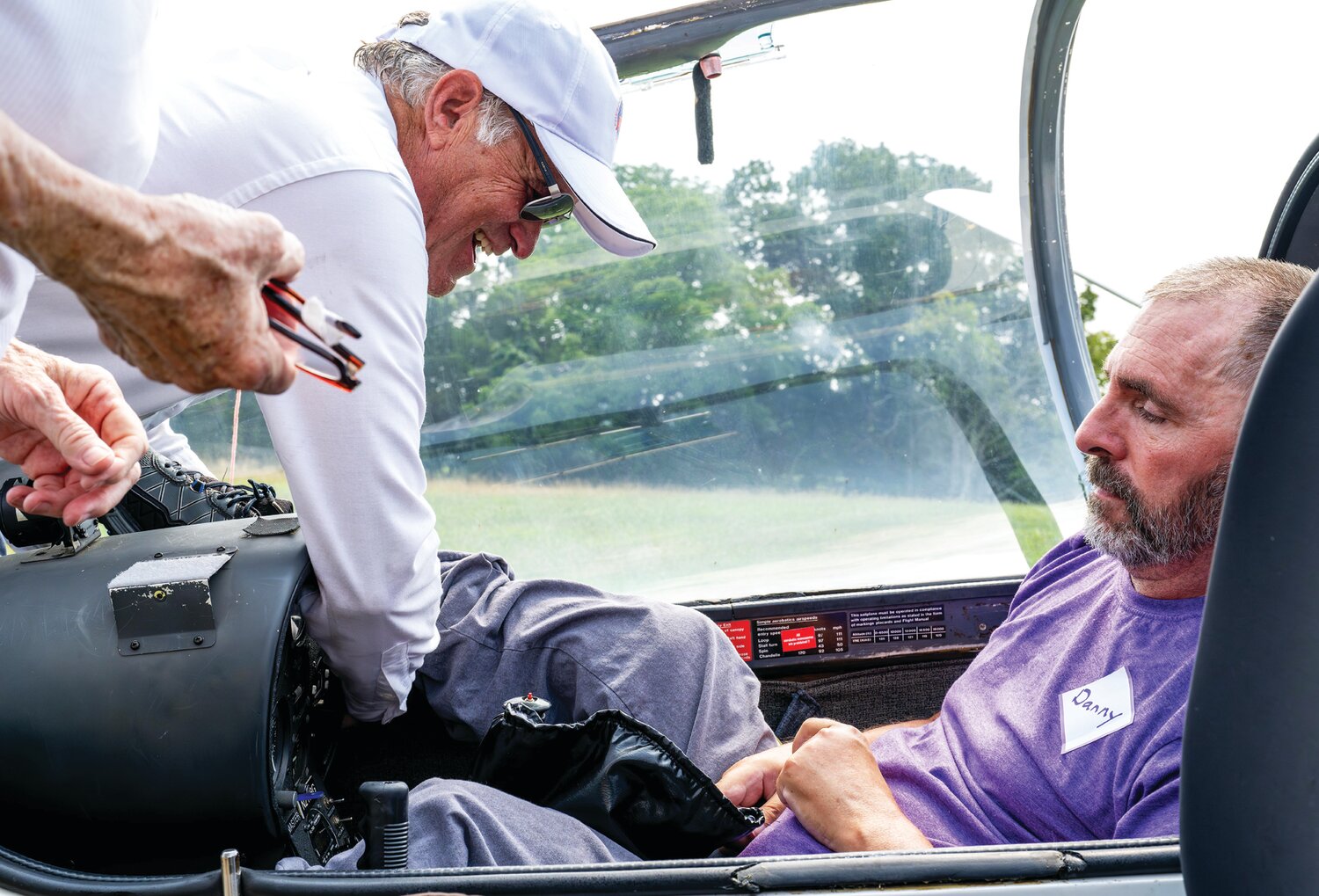 Gil Frost, president of Freedom’s Wings International, helps Daniel Dubinski get settled into a sailplane at Van Sant Airport in Tinicum.