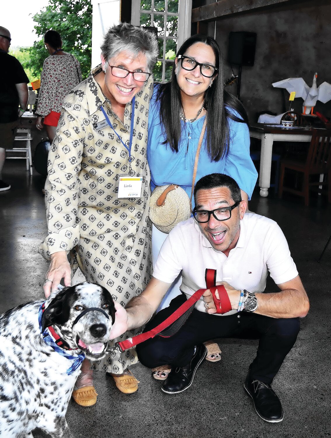 Linda Reider, SPCA executive director, with the Saiases and dog Rudy.