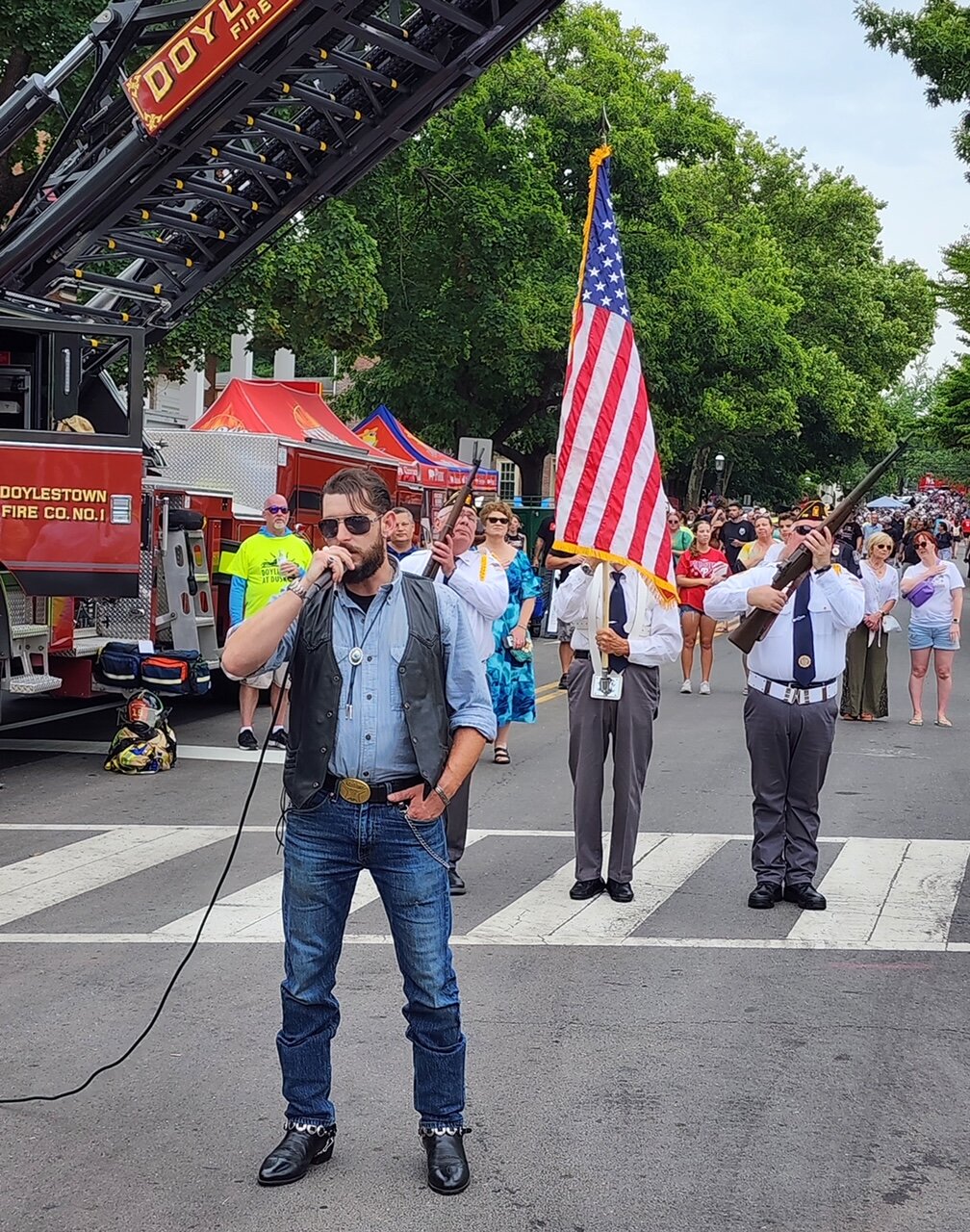 Ryan Williams, lead singer from Springbrooke, sings the national anthem.