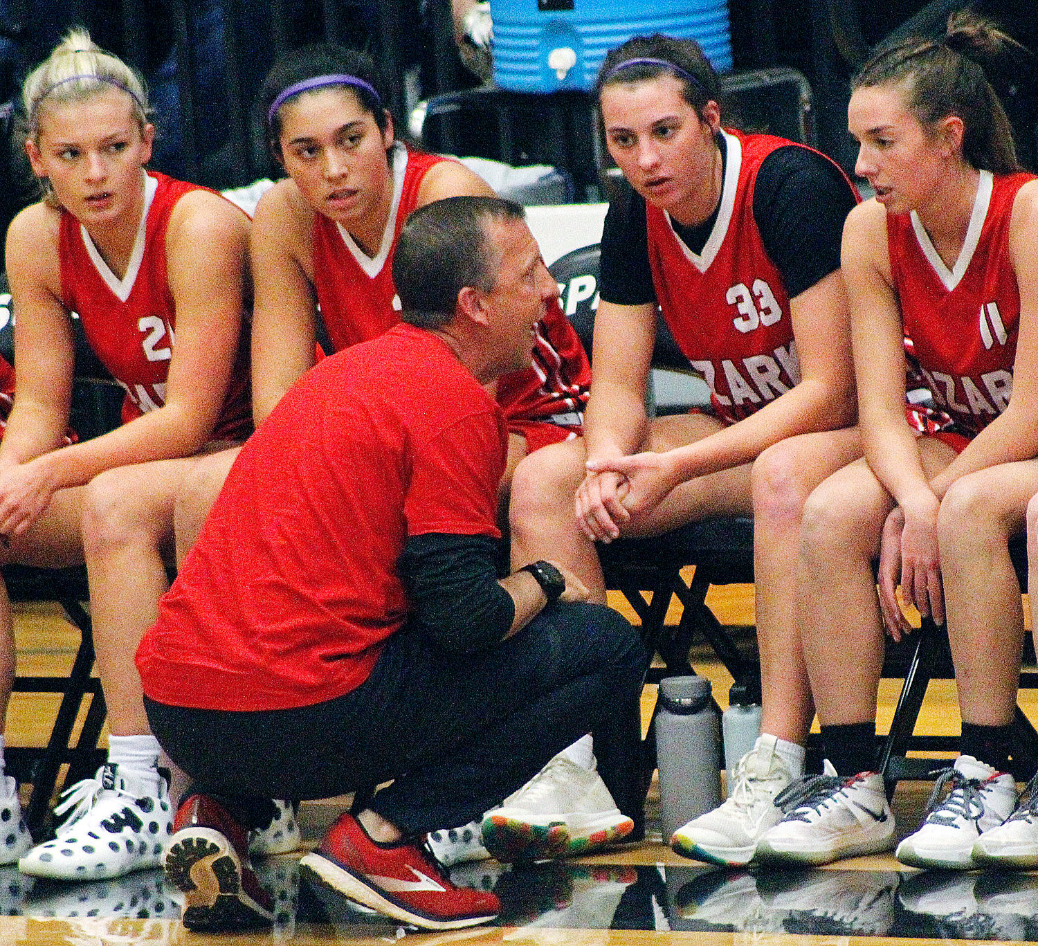 OZARK’S DOUG HEPLER talks strategy with his players during jamboree action.