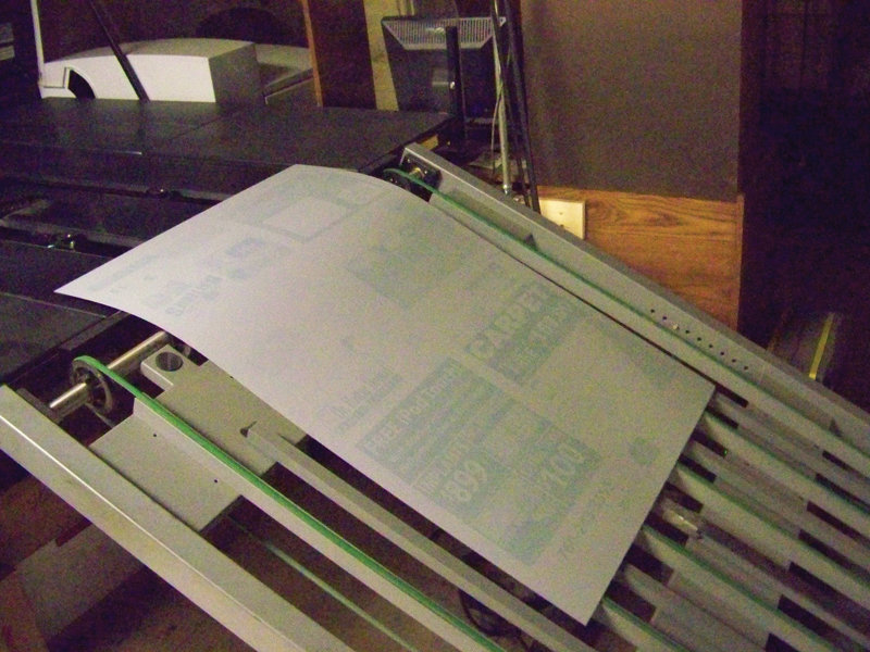 After being imaged the Computer-To-Plate unit drops, the faintly imaged processless plate, which is bent and locked up on press to be developed. (Photo by Jerry Simpkins)