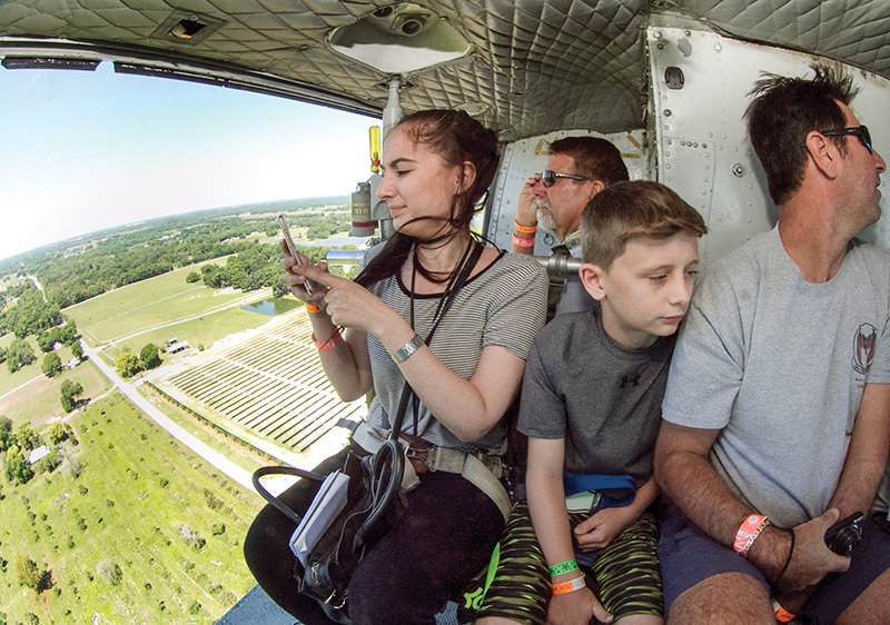 Ledger reporter Madison Fantozzi uses Snapchat from a Vietman War-era Huey helicopter as it comes in for a landing during the 42nd Annual SUN 'n FUN International Fly-In & Expo in Lakeland. (Photo by Michael Wilson/The Ledger)