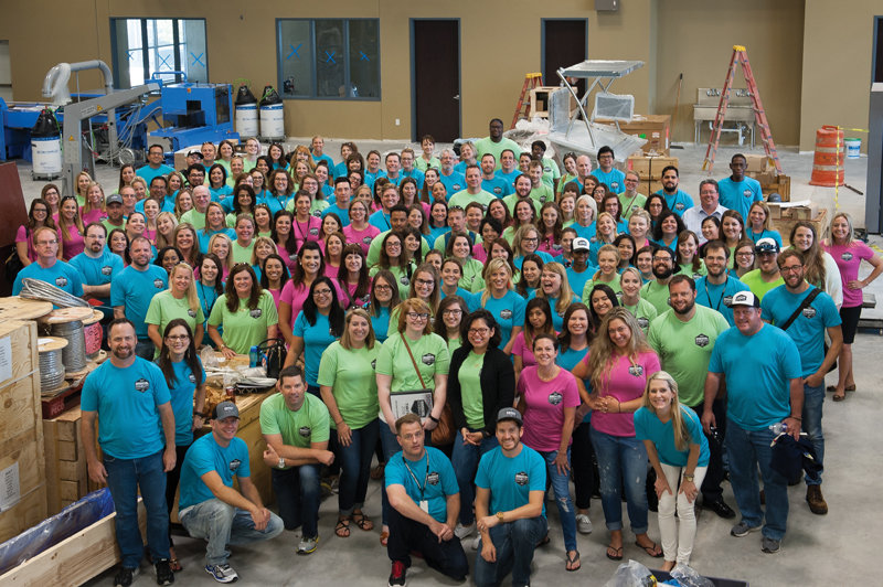 The Community Impact Newspaper staff stands inside the new printing facility during construction. 
