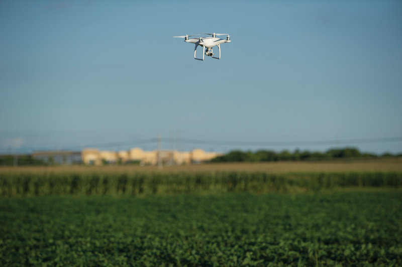 A DJI Phantom 4 drone hovers over a University of Nebraska-Lincoln farm during a demonstration flight at the first ever Drone Journalism Boot Camp.