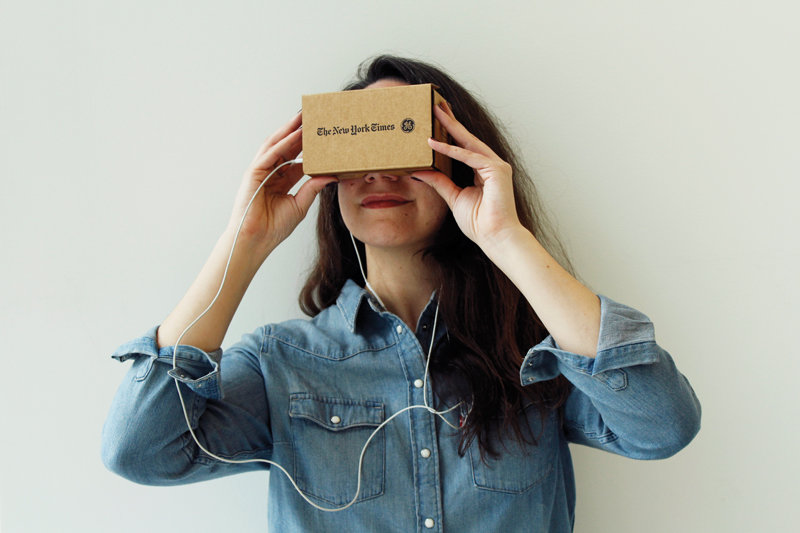 Jenna Pirog with a Google Cardboard virtual reality viewer.