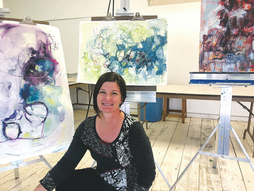 Nikki Nienhuis sits with her artwork in Foothills Art Center&rsquo;s Open Studio Classroom. Nienhuis of Golden is now in two Colorado galleries &mdash; Georgetown&rsquo;s Colorado Mountain Art Gallery and Portfolio in Breckenridge, which is a new gallery that had its grand opening on Aug. 3.