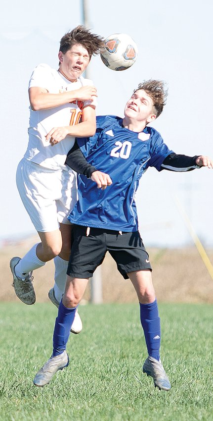 Lincolnwood's Kennedy DeWerff gets a head on a ball over Carlinville's Brody Harris during the regional championship game at Terry Todt Field in Raymond on Oct. 16. The Lancers would score first against the top seeded Cavaliers, but Carlinville would answer and take a 3-1 victory over the orange and black.