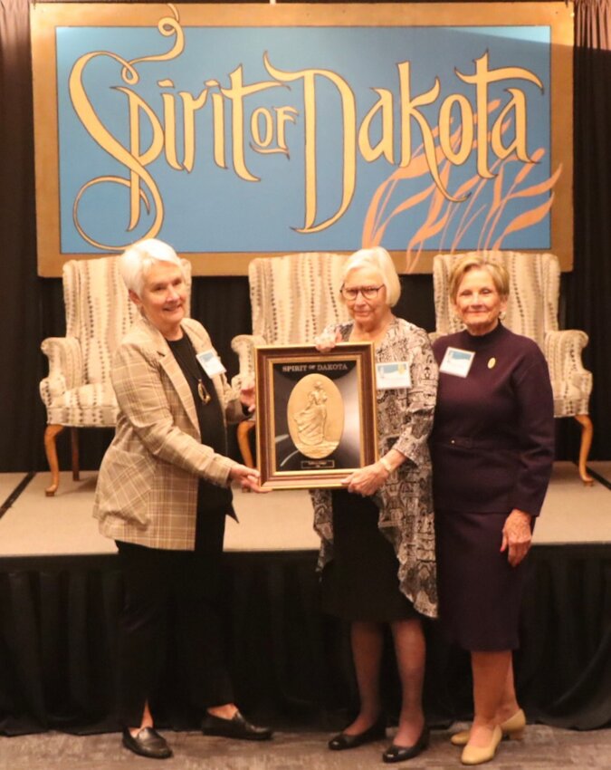 Tona Rozum, Sprit of Dakota selection commission chair, left, and Marilyn Hoyt, right, Spirit of Dakota society chair, present the 2024 Spirit of Dakota Award to LaVonne Gaspar of Sioux Falls.