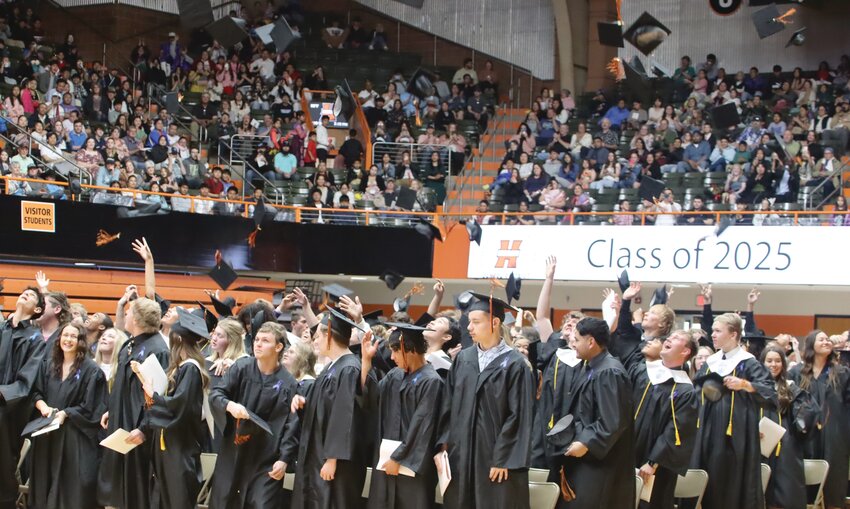 Graduates toss their caps in the air at the conclusion of the ceremony.