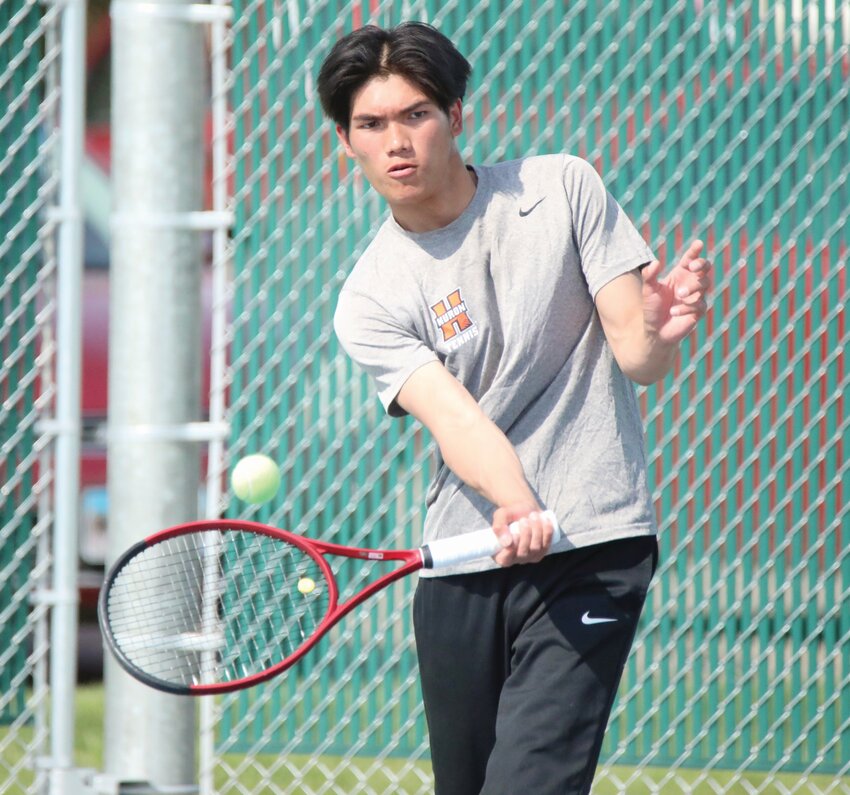 Huron’s Aung Myit plays a shot during a triagular on May 6 at Huron Courts.