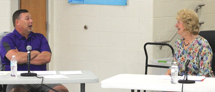 Retiring school district superintendent Rick Weber shares a lighter moment with school board member Cynthia Sheppard during the board’s June 9 meeting.