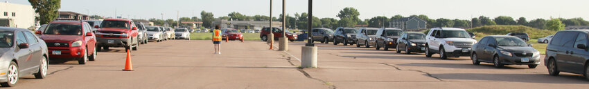 The cars awaiting backpacks were split into two lines as they entered the Faith Alive parking lot.