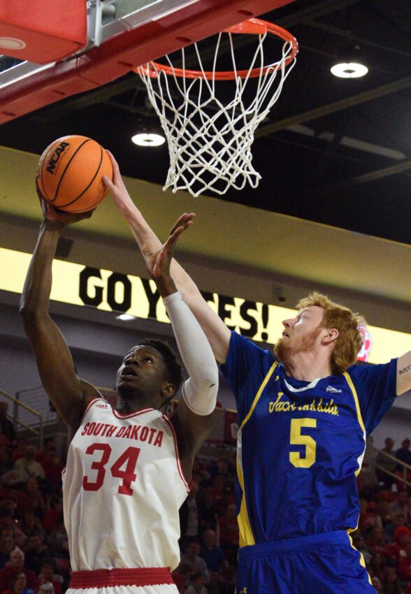 South Dakota State's Nate Barnhart, 5, blocks the shot of South Dakota's Lahat Thioune from behind during their Summit League men's basketball game earlier this year at the Sanford Coyote Sports Center in Vermillion.