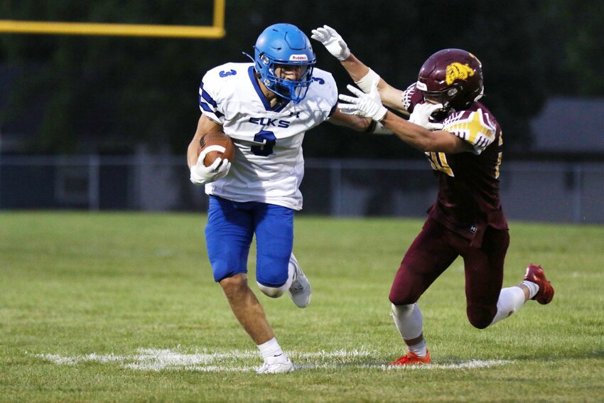 Elkton-Lake Benton’s Tanner Stein (3) breaks a tackle against DeSmet’s Slayten Wilkinson and scores from 45 yards out during the second quarter of the Elks 42-0 win over the Bulldogs Friday night in DeSmet. Stein would score 5 touchdowns on the night.