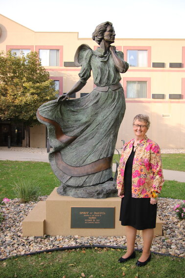 2023 Spirit of Dakota award winner Julie Bell, Brookings, stands near the Spirit of Dakota sculpture, the source of inspiration for the award honoring women for their outstanding contributions to their communities and state. This year’s recipient, along with all nominees, will be recognized during this year’s festivities set for Oct. 12 at the Huron Event Center.