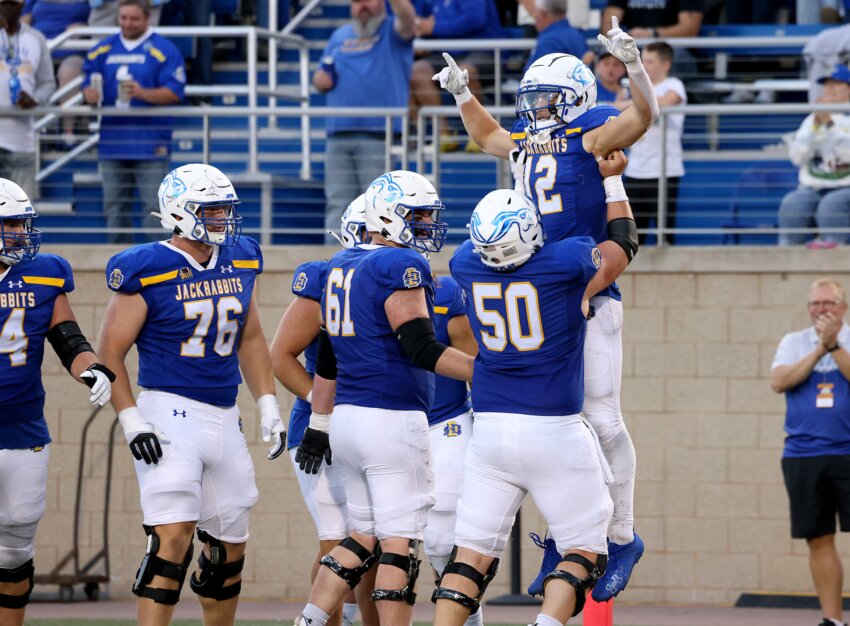 BROOKINGS, SD: September 7: Grahm Goering #12 is hoisted by teammate Gus Miller #50 of the South Dakota State Jackrabbits after a touchdown at Dana J. Dykhouse Stadium on September 7, 2024 in Brookings, SD. (Photo by Dave Eggen/Inertia)