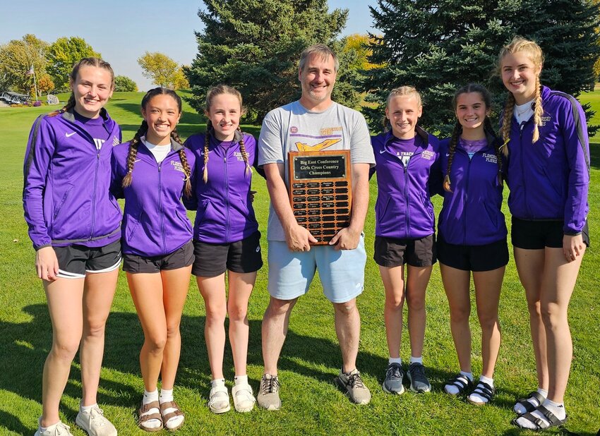 These six members of the Flandreau girls cross country team not only won the Big East Conference Meet last Thursday, but they helped their Coach Brendan Streitz earn his 75th championship title. All-Conference team members are from left, Faith Wiese, Kiley Westberry,  Tenley LeBrun, Coach Streitz, Calla Wiese, Josie Hamilton and Morgan Sheppard.    Submitted photo