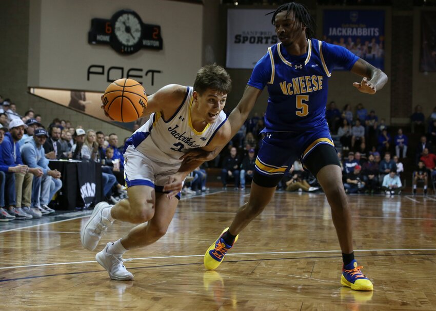 South Dakota State guard Joe Sayler gets past McNeese State's Joe Charles in the first half of a game at the Sanford Pentagon in Sioux Falls on Nov. 4.