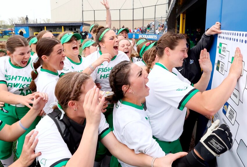 The North Dakota softball team slaps their name on the bracket after beating North Dakota State and advancing in the Summit League Tournament on Wednesday in Brookings.