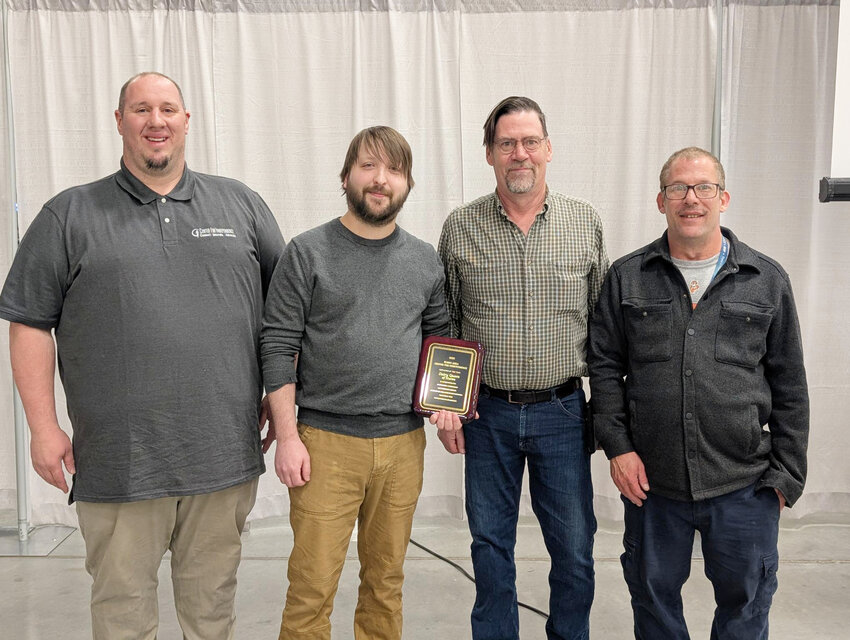 Brent Adams, left, and Jay Podhradsky, right, present the Employer of the Year award to general manager Austin Duxbury and owner Jeff Lund from Dairy Queen in Huron.