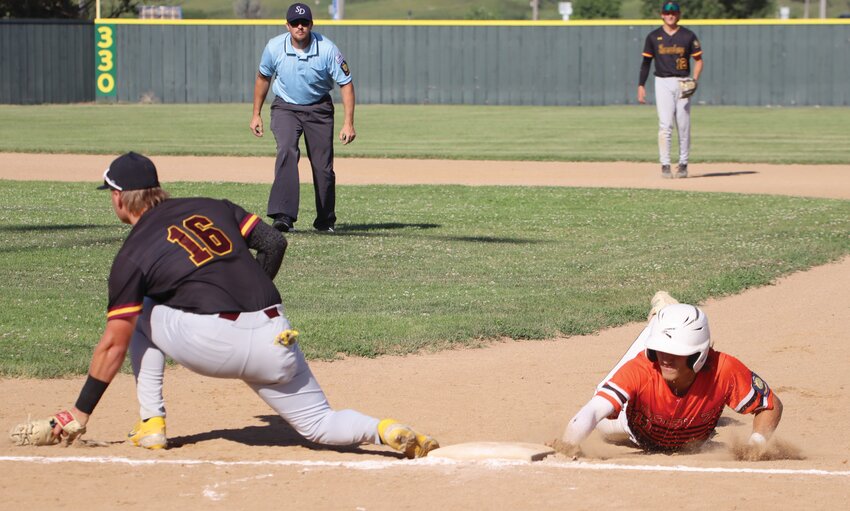 Huron’s Bubba Peterson dives back to first base on a pickoff attempt as Harrisburg’s Noah Boschee receives the throw during a game Tuesday at Memorial Park Stadium.