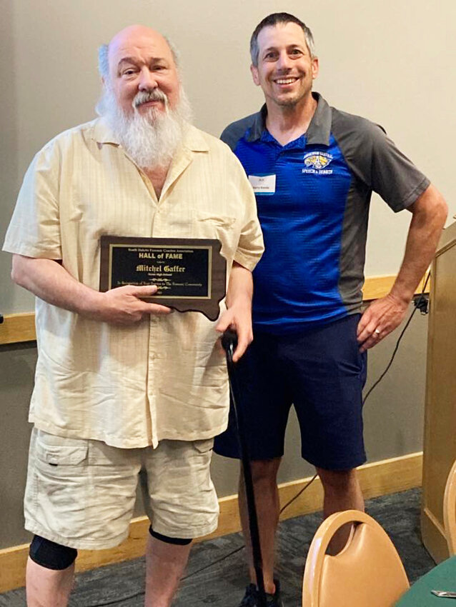 Mitch Gaffer, at left, is inducted into the South Dakota Debate Coaches Hall of Fame by Kerry Konda, Aberdeen Head Coach and Northern South Dakota District Chair.