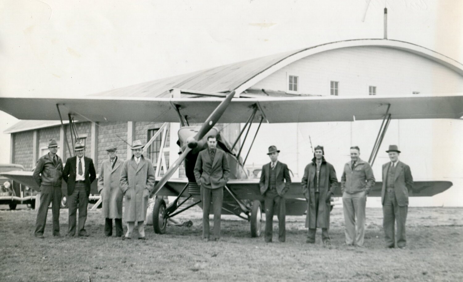 Brookings airport officials joined with postal officials in front of the new domed hangar at the Brookings Airport at 8 a.m. on May 19, 1938, to deliver the city’s first airmail letters to be flown out of Brookings.