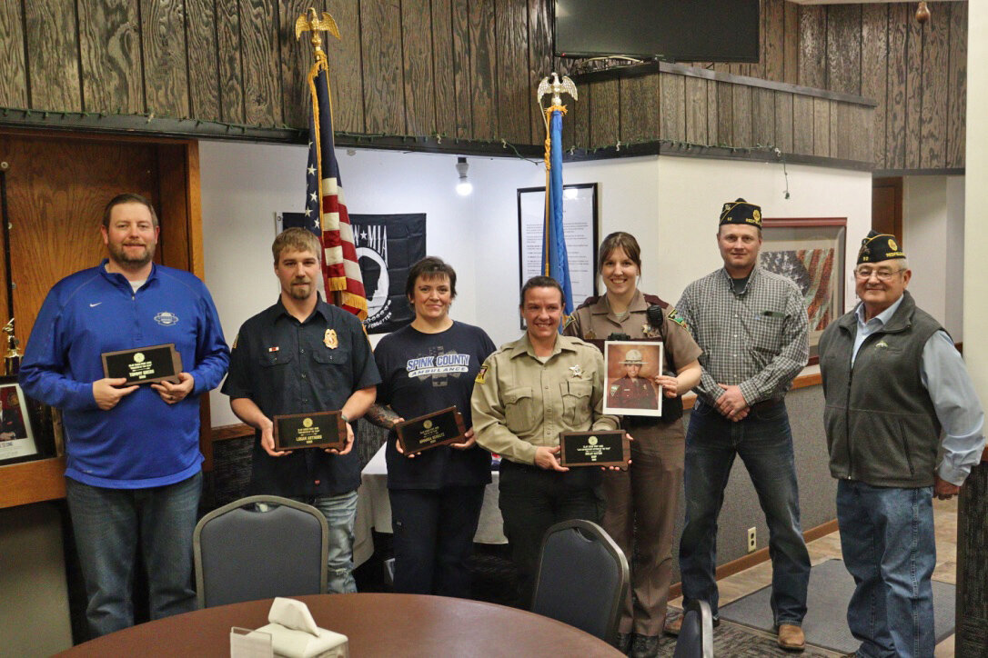 Educator Tommy Gregg; Firefighter Logan Arthurs; EMT Amanda Schultz; Sheriff Jenna Appel; State Trooper Joelle Schuknecht, holding a photo of awardee State Trooper Shelby Hattum; Post Commander Brad Englund; Post Public Safety Chair Larry Price