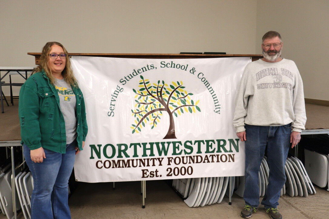 Chair Jessica Halvorson and retiring board member Donnie Stahl stand by the Mellette Community Foundation sign.