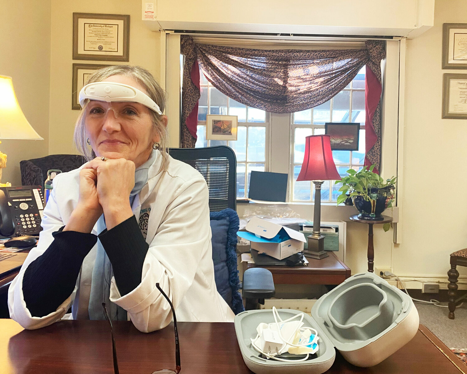 Dr. Linda Carpenter, M.D., models the Relivion, a take-home device for treatment at her office at Butler Hospital.